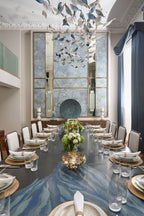Chandelier for double‑height space, minimalist style for living and dining rooms, atmospheric artistic golden twisted‑leaf glass