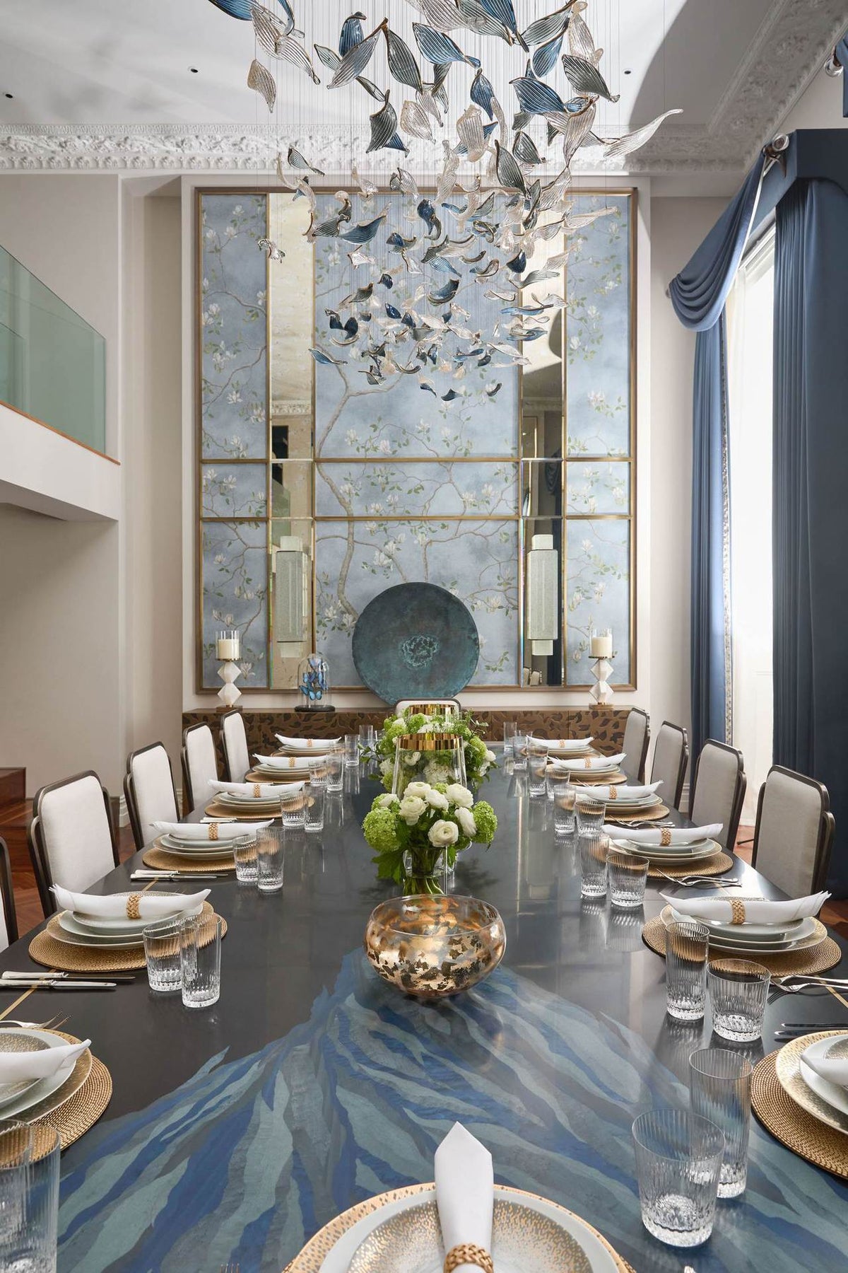 Chandelier for double‑height space, minimalist style for living and dining rooms, atmospheric artistic golden twisted‑leaf glass